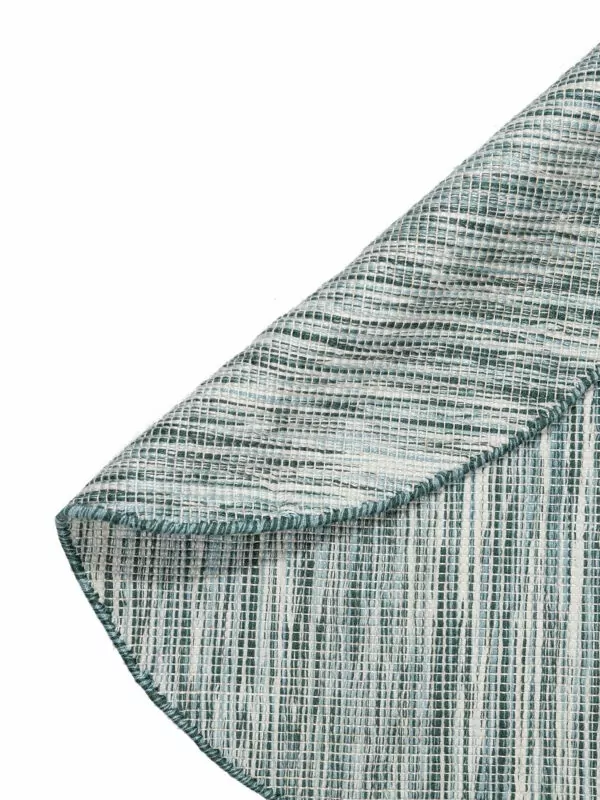 Detail van rond vloerkleed met aqua groene kleuren